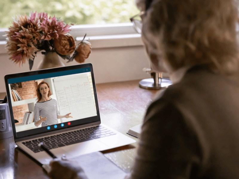 Woman watching webinar, using laptop