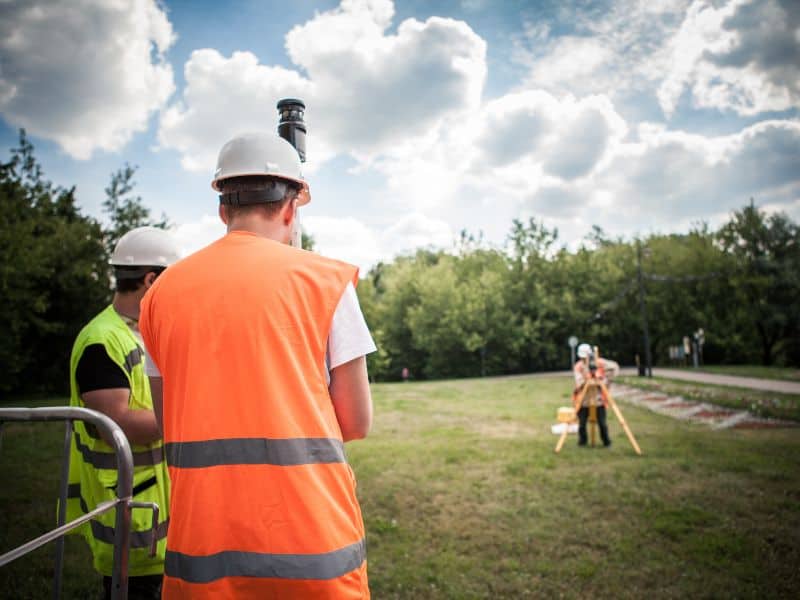 Environmental impact assessors on field survey for construction project