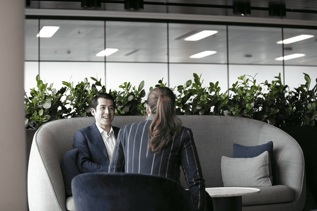 Two IEMA members sitting in an office space talking