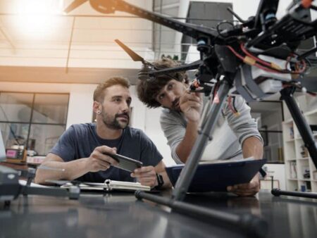 Two students work on drone technology