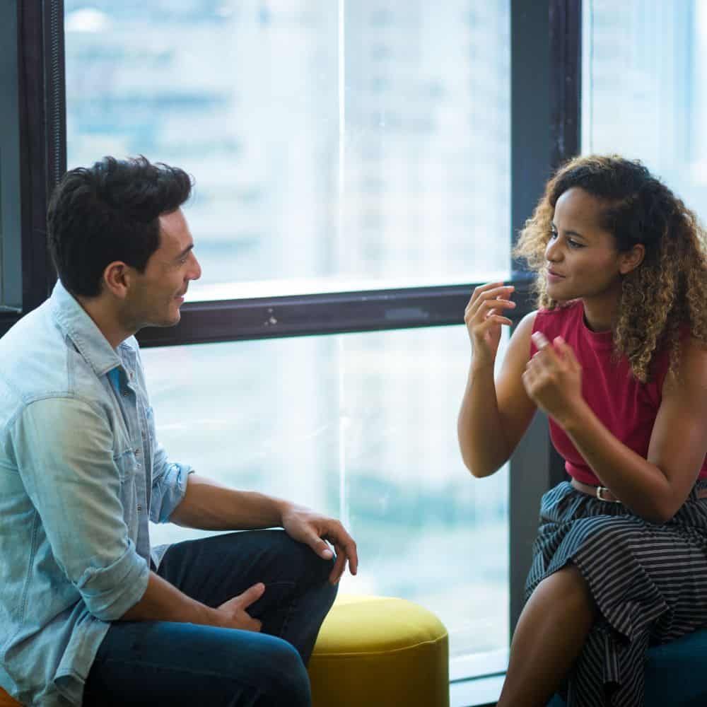 Woman and man talking in an office building