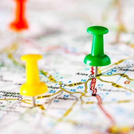 Road map with coloured pins stuck on.