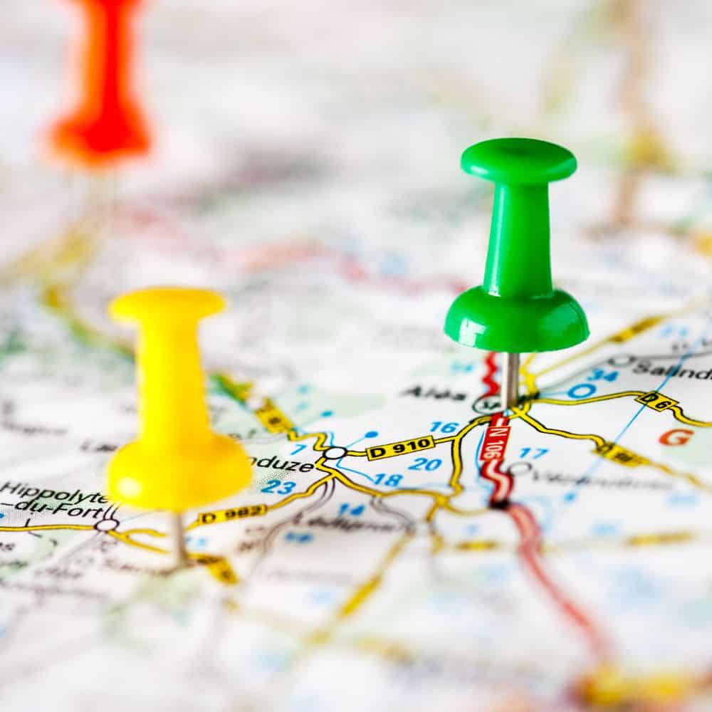 Road map with coloured pins stuck on.