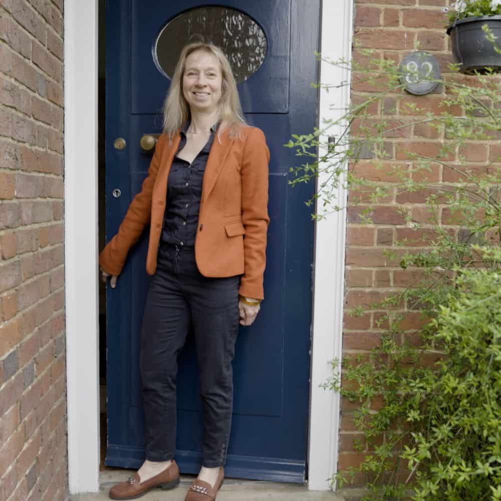 Photo of Cathie Mackay by a house front door