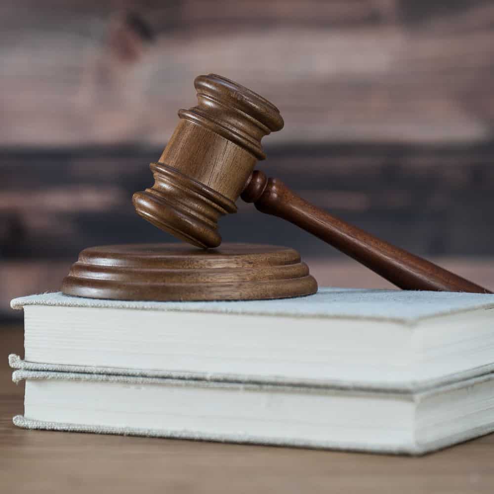 Two books with dark wooden gavel.