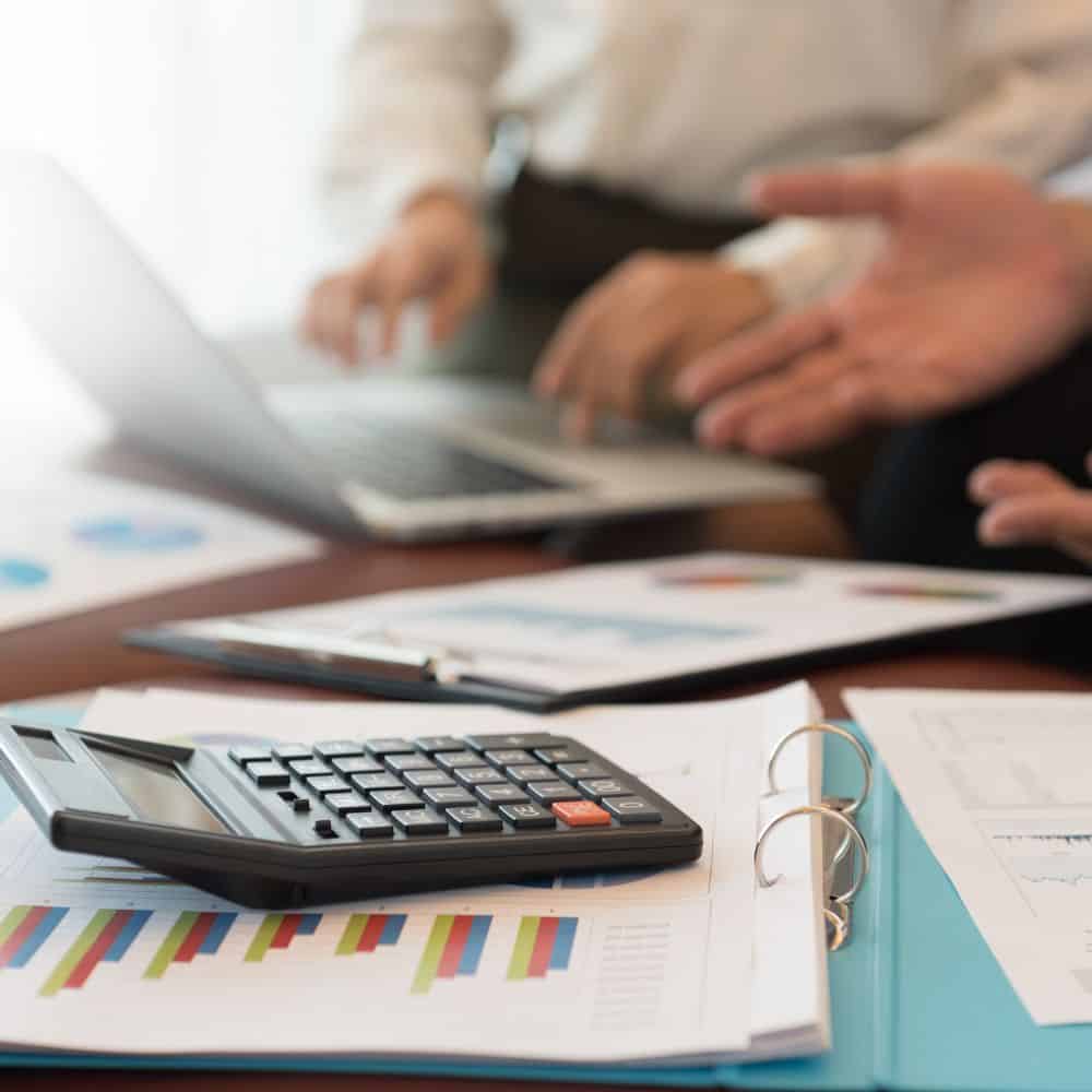 Desk with folders and calculator.