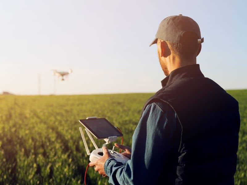 Man operating a drone in a field