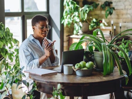 Woman working on laptop in green office