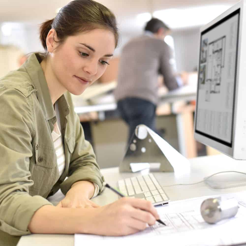 Woman design engineer is working on a design on a computer