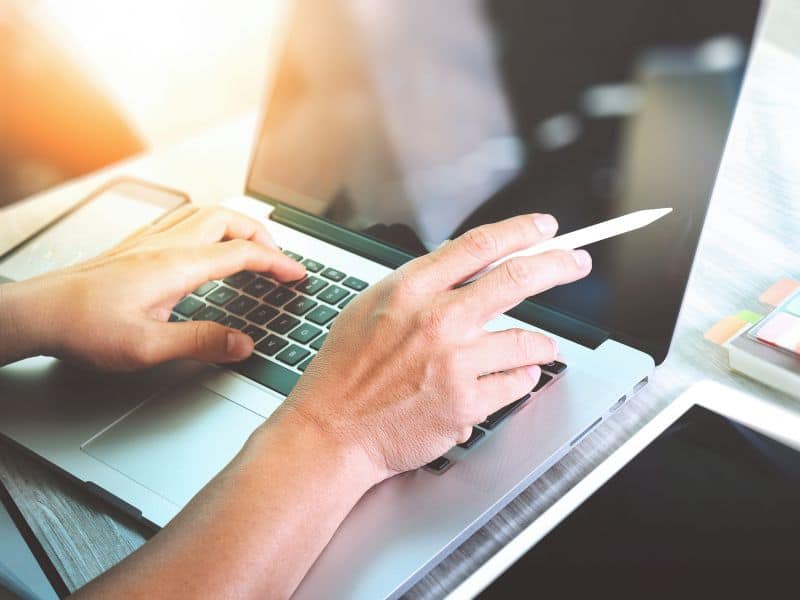 Image of hands on a laptop