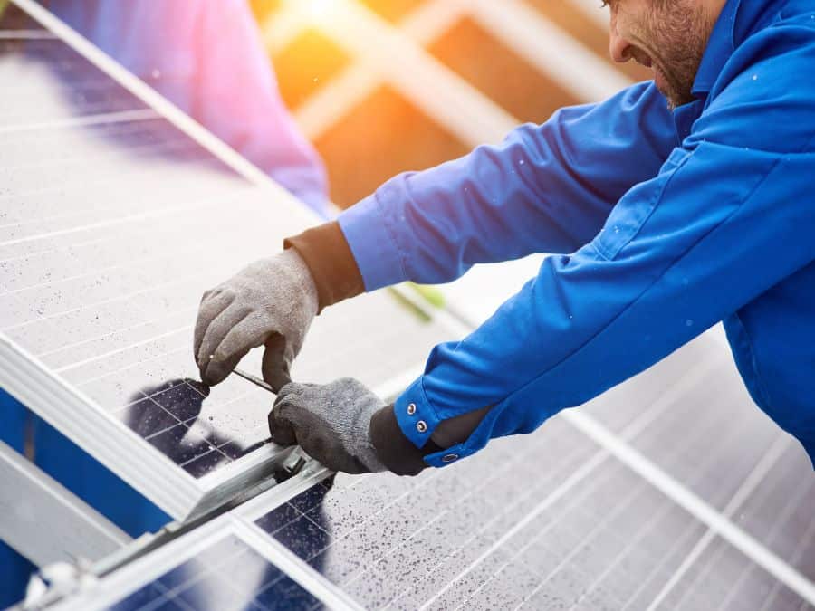 Electrician installing a solar panel