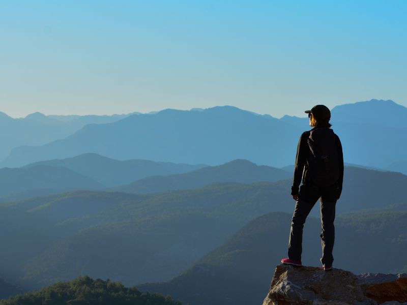 Image of person on top of a mountain looking out into the distance