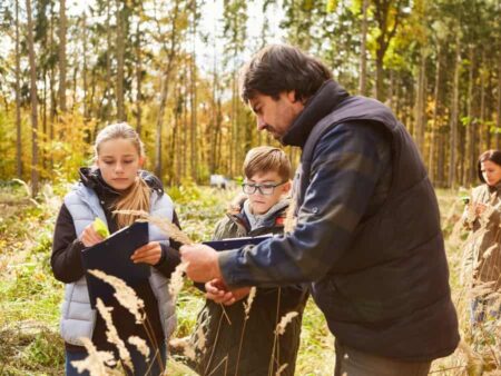 Forester educating children in the woods