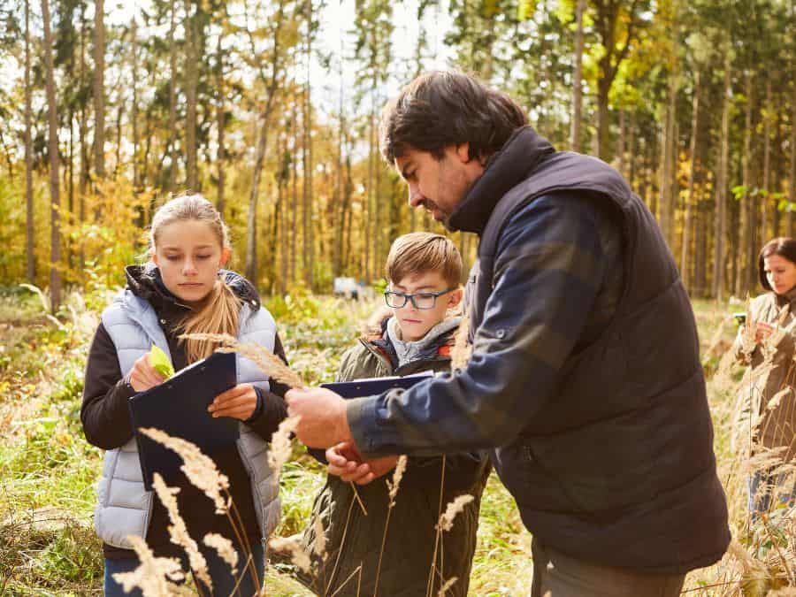 Forester educating children in the woods
