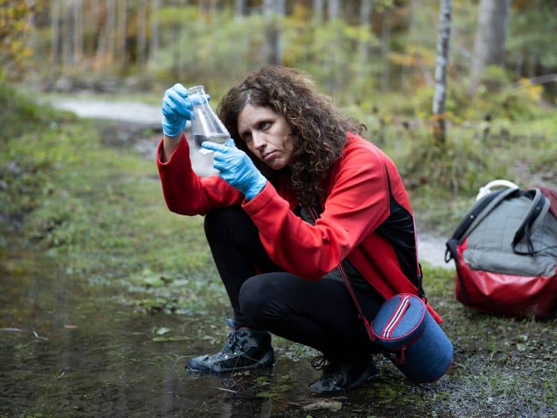 Hydrologist examines a water sample