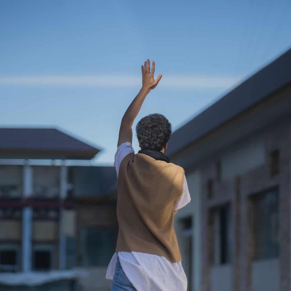 Image of boy or man holding his hand in the air