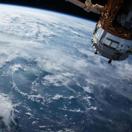 Image of satellite in space with earth in the background