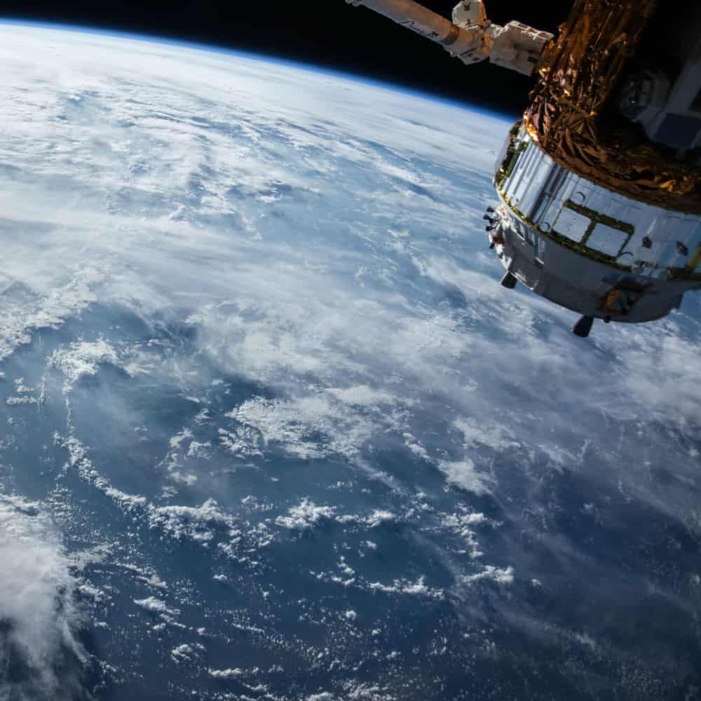 Image of satellite in space with earth in the background