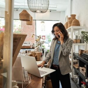 Shop owner on phone in a homeware shop