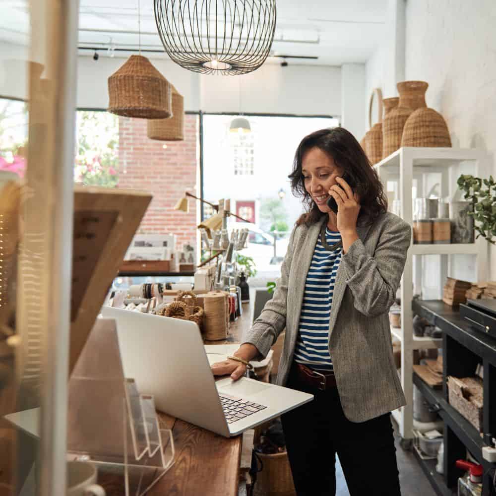 Shop owner on phone in a homeware shop