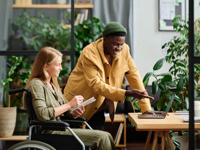 Two sustainability professionals talking in an office