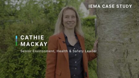 Photo of Cathie Mackay next to a large tree in her garden