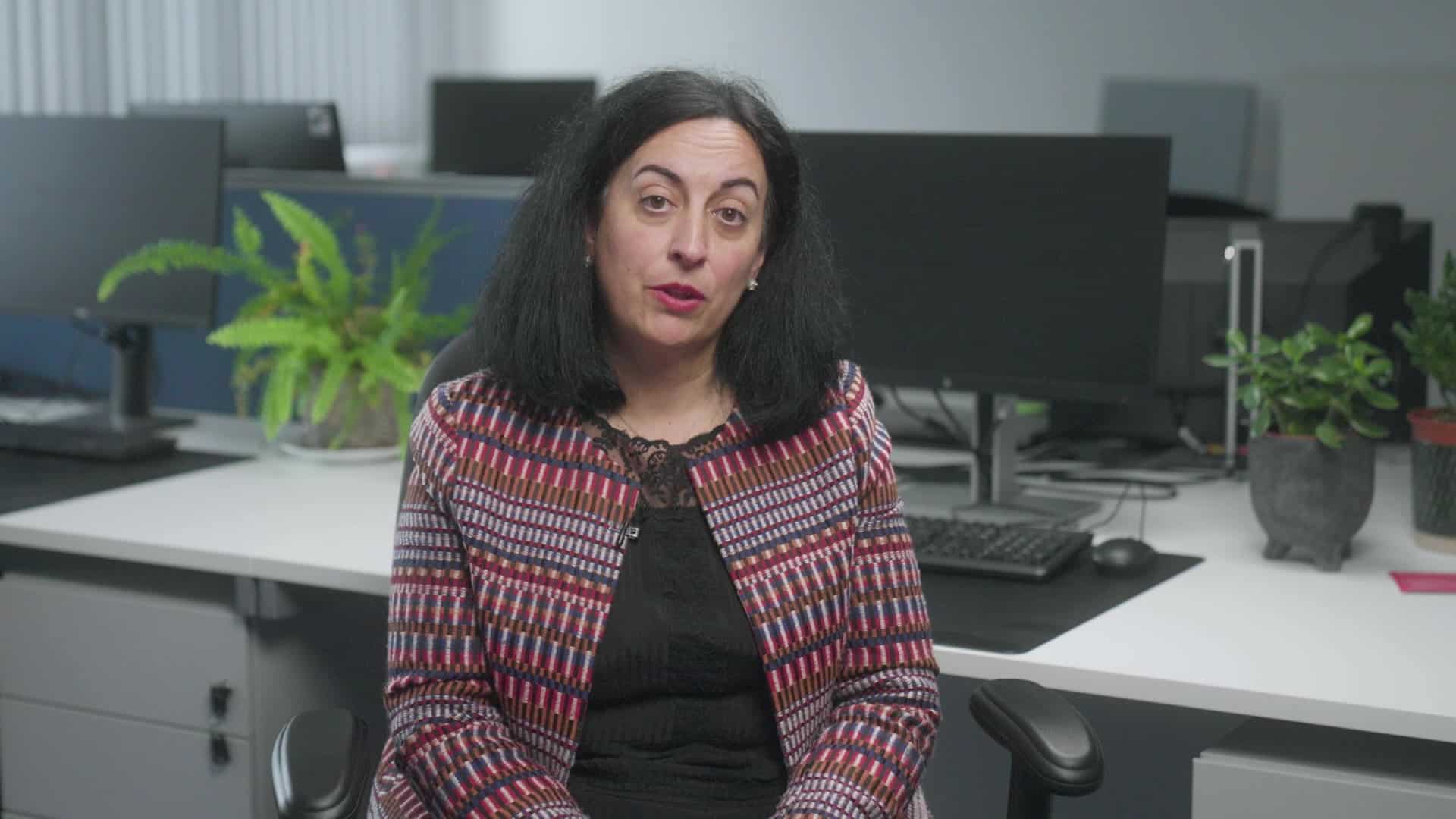 Thought leadership video thumbnail for IDRIC. Woman sitting in an office space.