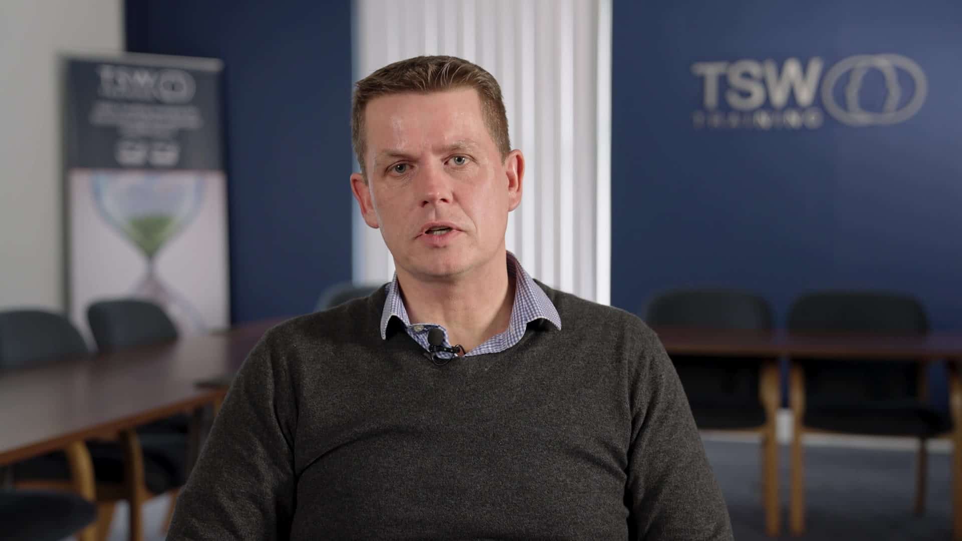 Thumbnail of TSW thought leadership video. Man speaking to the camera, sitting in a classroom.