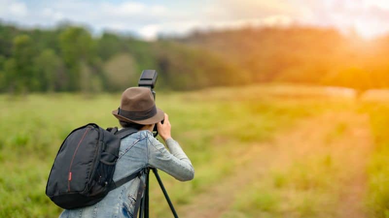 Image of person taking a photograph in a field
