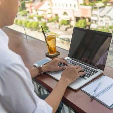 Person working on laptop overlooking a city