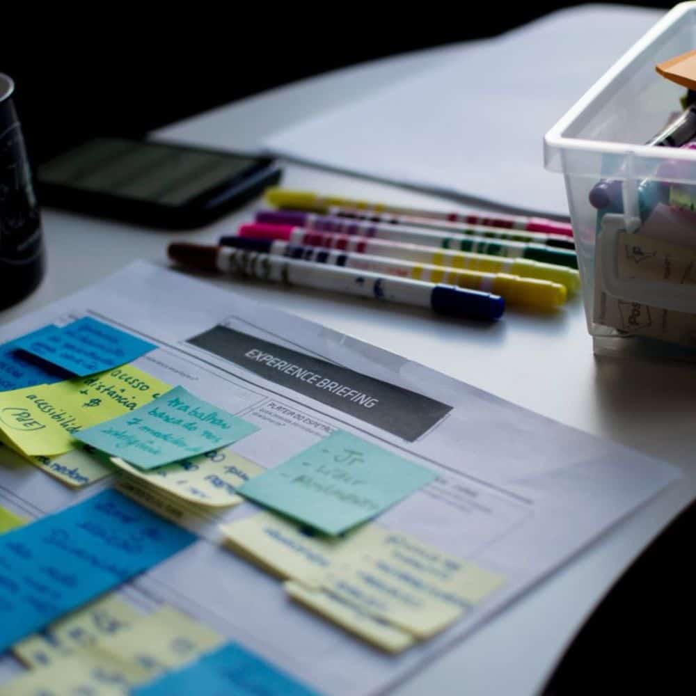 Sticky notes and coloured pens on a desk