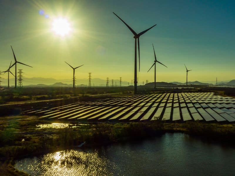 Photo of wind turbines and solar panels in a field