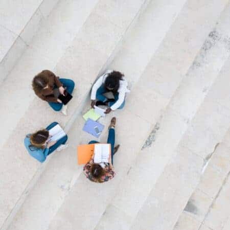 aerial shot of four students working on some steps
