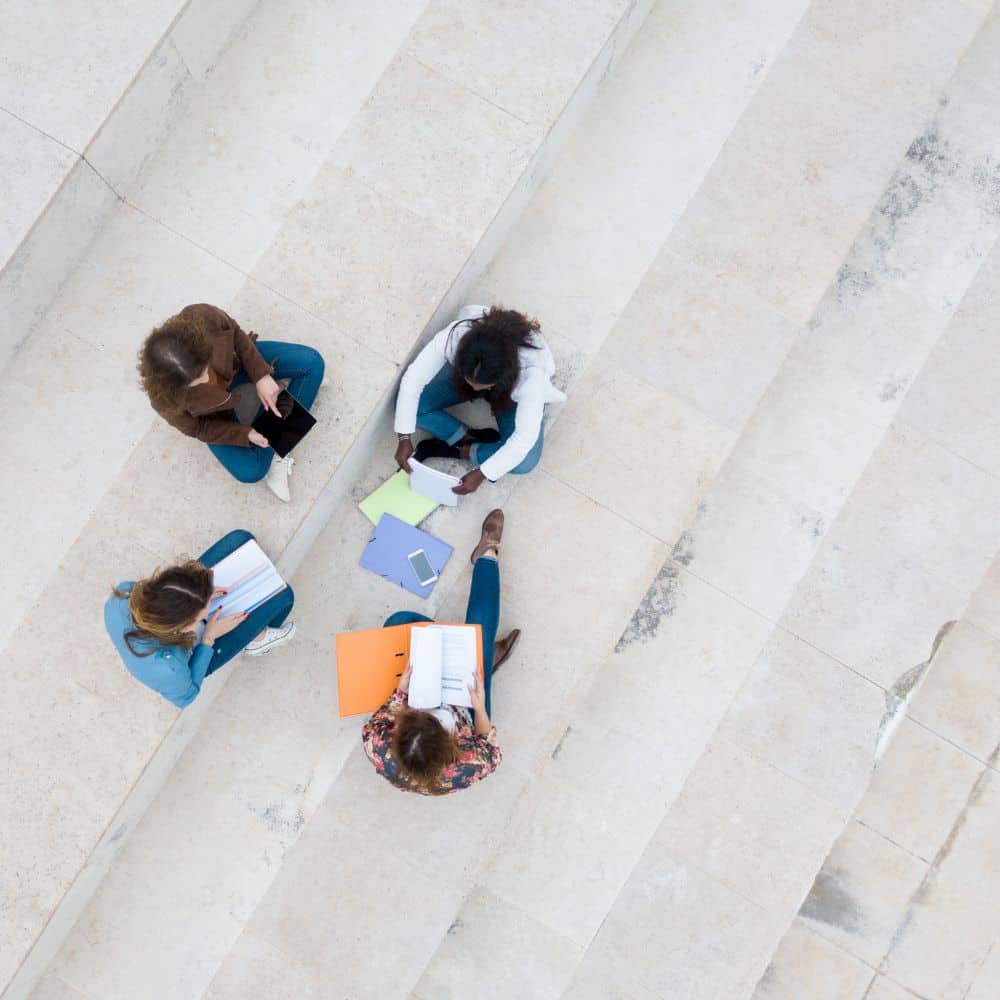 aerial shot of four students working on some steps