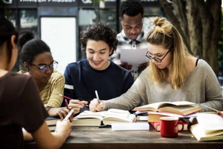 Four people working/studying at a table