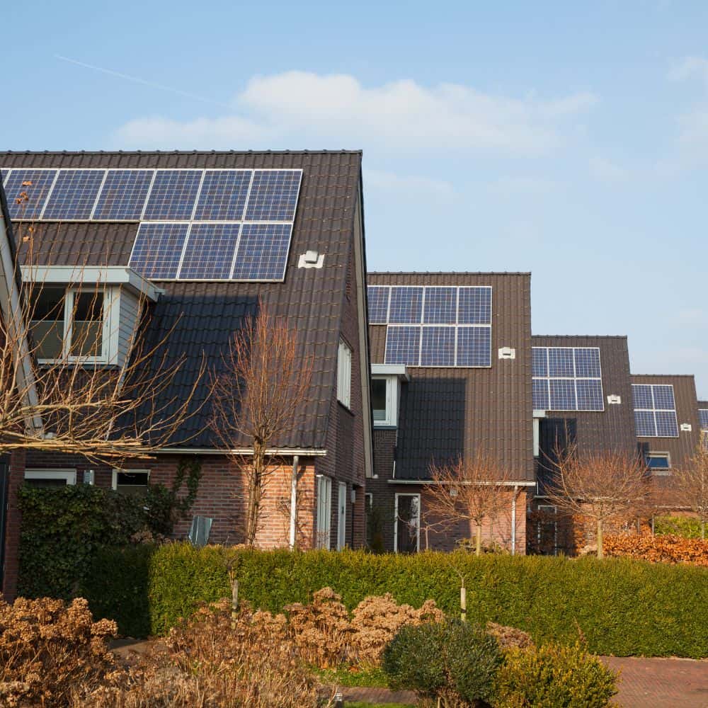 Row of houses with solar panels on the side of their roofs