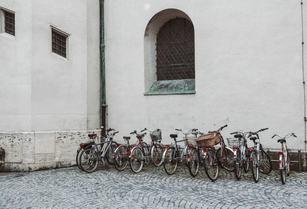 Photo of bicycles lined up along the side of a building