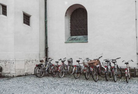 Photo of bicycles lined up along the side of a building