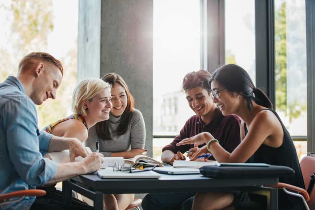 Five people working and talking around a table