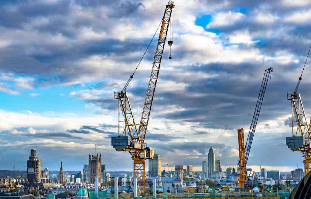 Photo of cranes/construction across a skyline