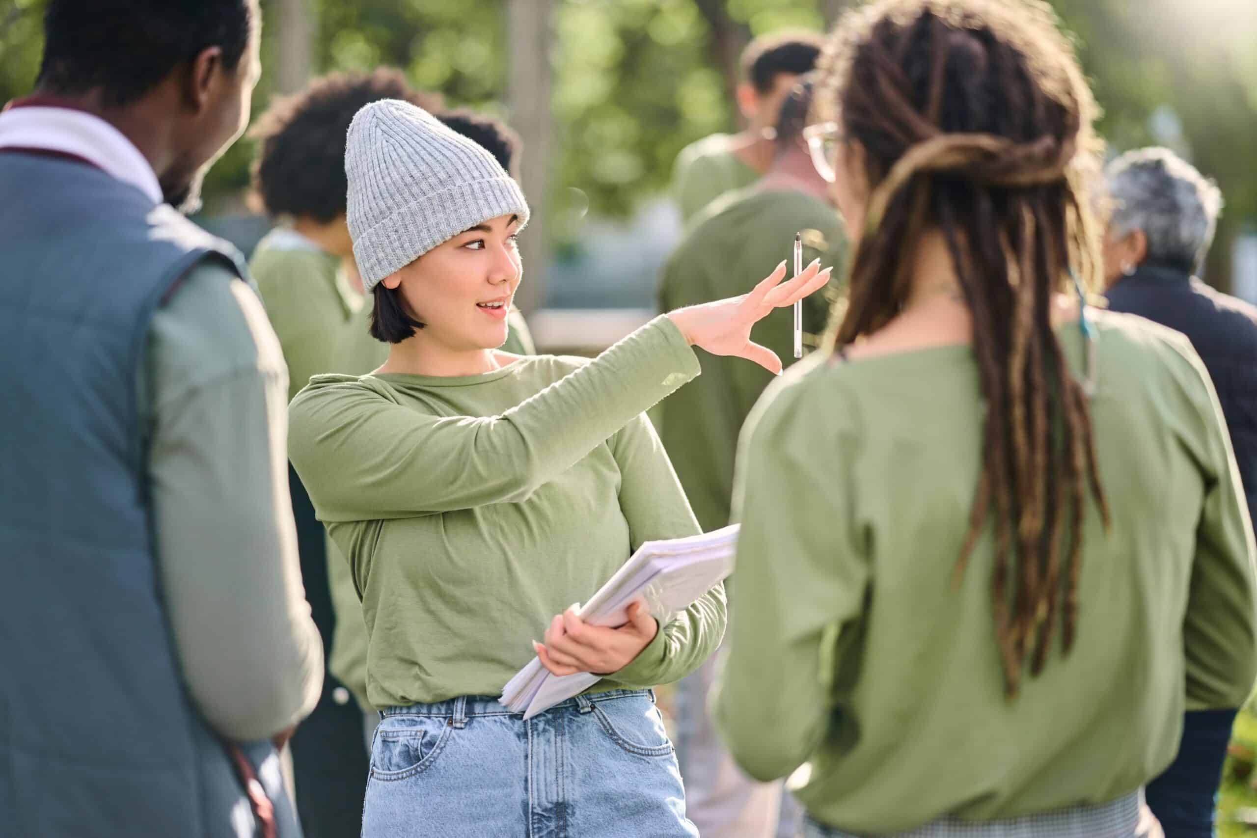 Woman orgnanising a group of people outdoors