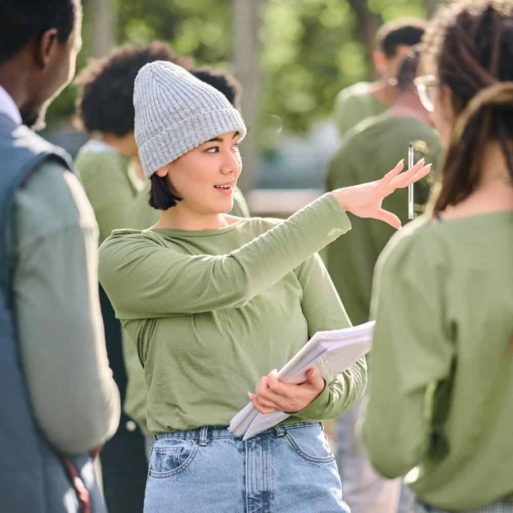 Woman orgnanising a group of people outdoors