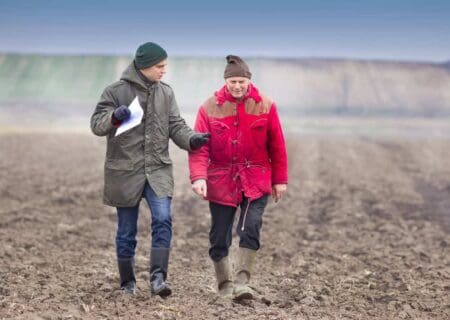 Two people walking in a field