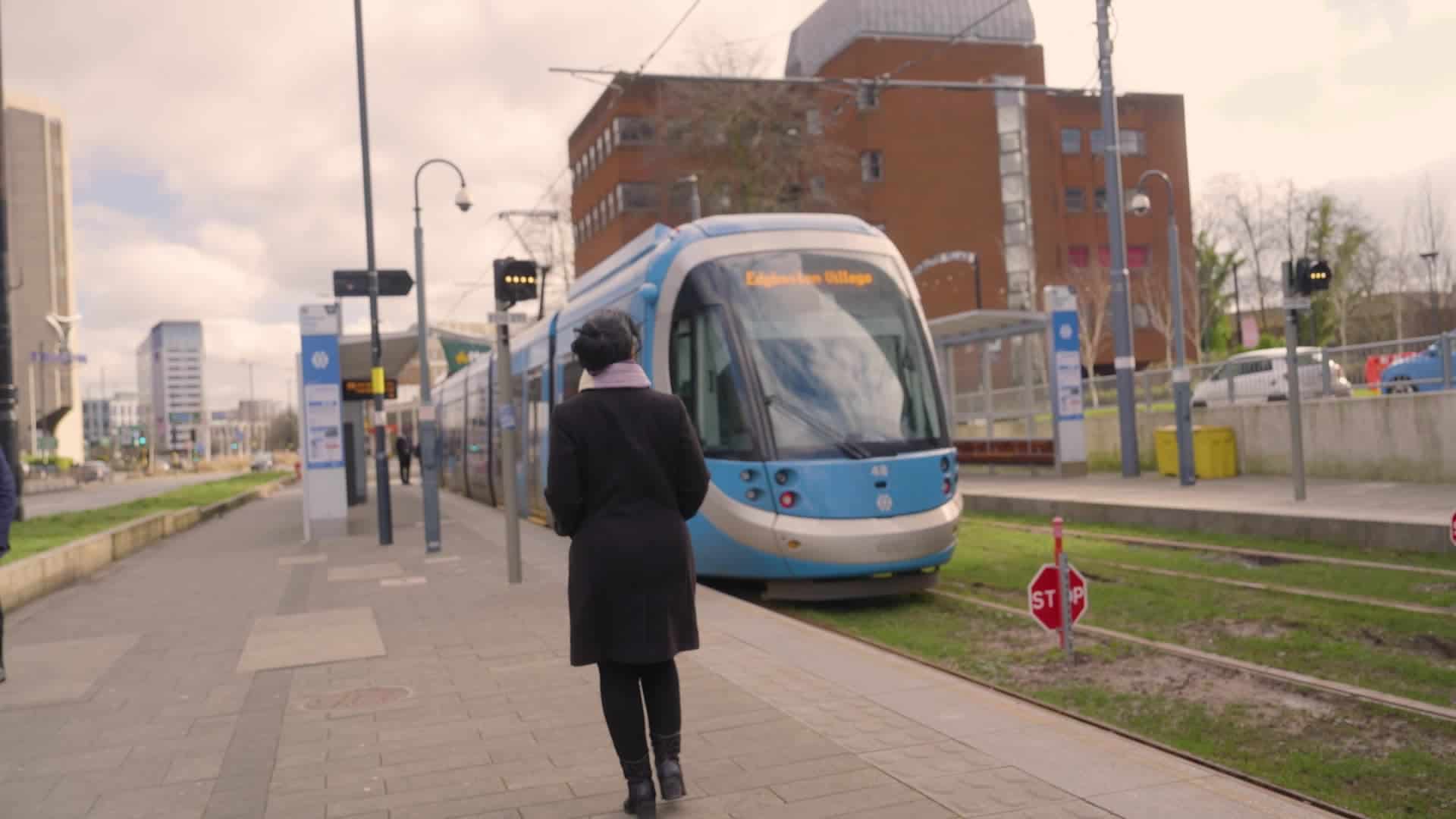Woman walking towards a tram