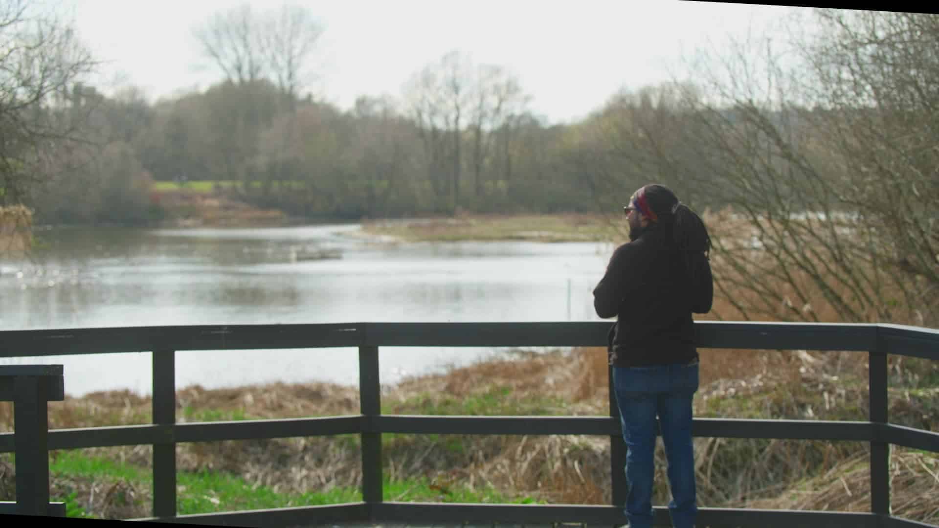 A person looking over at a lake