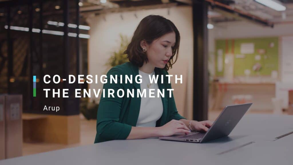 Woman from video sat working on a laptop. title reads: co-designing with the envionment