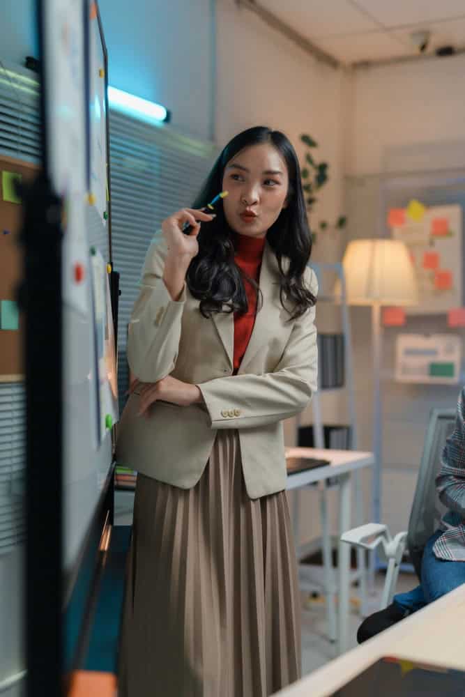 Woman in an office standing and talking on a mobile phone