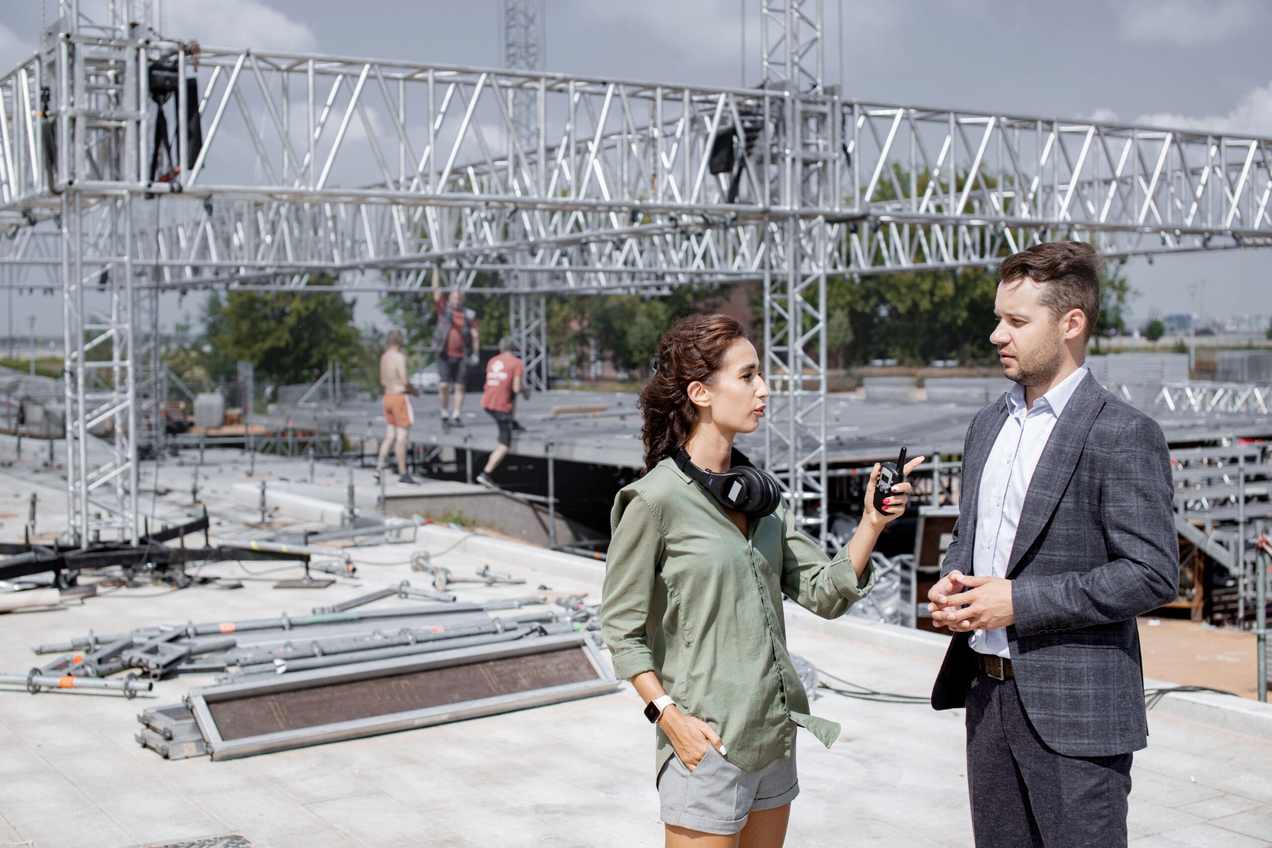 A man and a woman talking on a construction site
